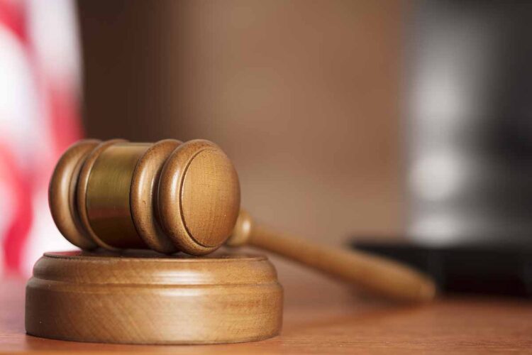 Court gavel resting on desk.