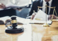 Court gavel and justice scales on a table.