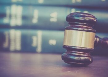 Court gavel with books in background.