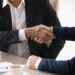 Two businessmen shake hands.