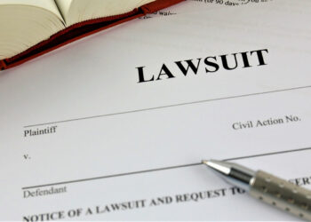 Documents to file a lawsuit with a pen.