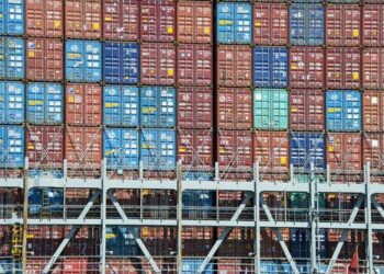 Shipping container stacked at a port.