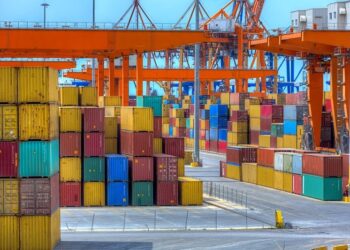 Shipping containers stacked at port.