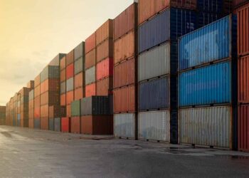 Shipping containers stacked at a logistic hub.
