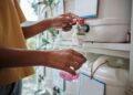 Person filling a bottle with product