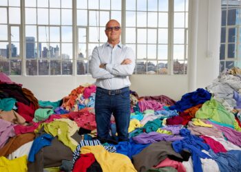 Reju CEO Patrik Frisk stands among textile waste