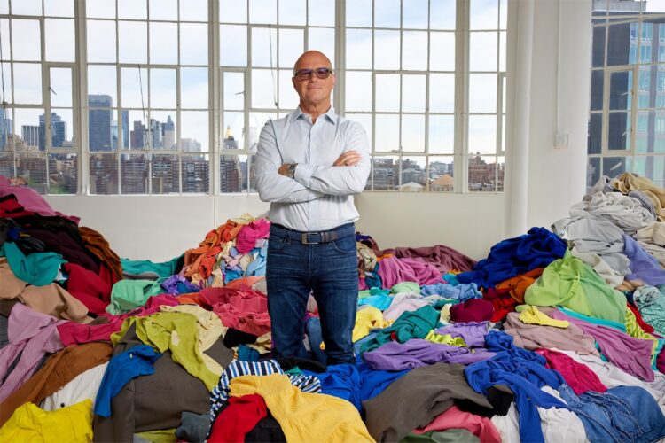 Reju CEO Patrik Frisk stands among textile waste